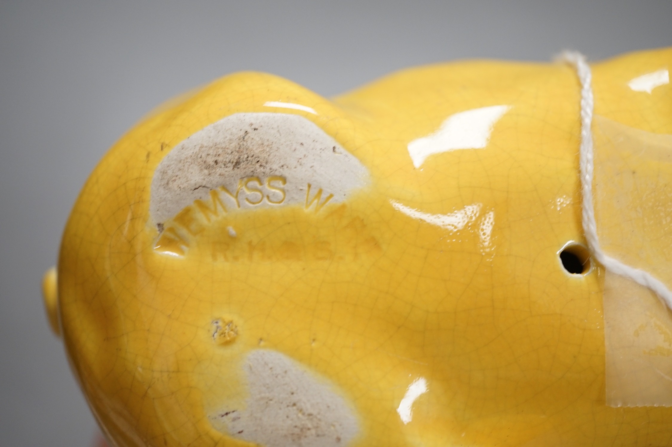 A Wemyss ware yellow glazed pig, 17cms long